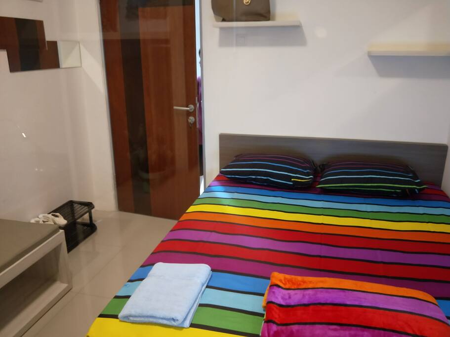 Queen sized bed, shoe rack, and sofa (on the right side)