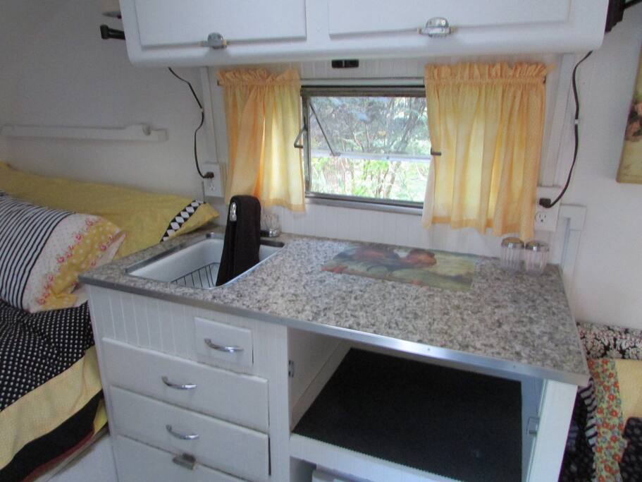 This kitchen is tiny, but there is a large kitchen in the main communal house with all the amenities.