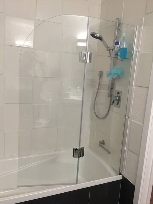 private bathroom with bath, shower, toilet, heated floor and towel rail