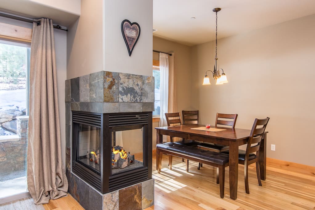 Enjoy a gas fireplace by the dining area in the open living space.