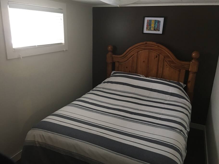 A cozy bedroom with cotton sheets, queen size bed, ergonomic pillow, and a large closet
