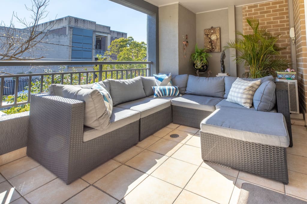 The large balcony off the living area serves as a terrace with comfortable sofa/lounge seats