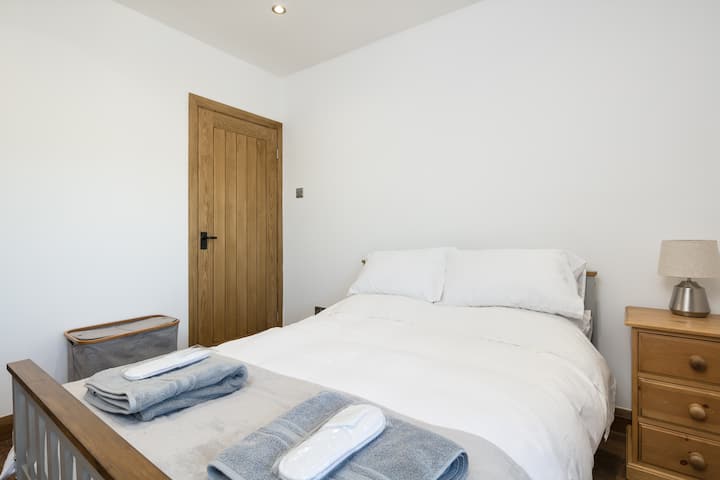 Bedroom 1 - double bed with walk-in wardrobe and ample drawer storage.