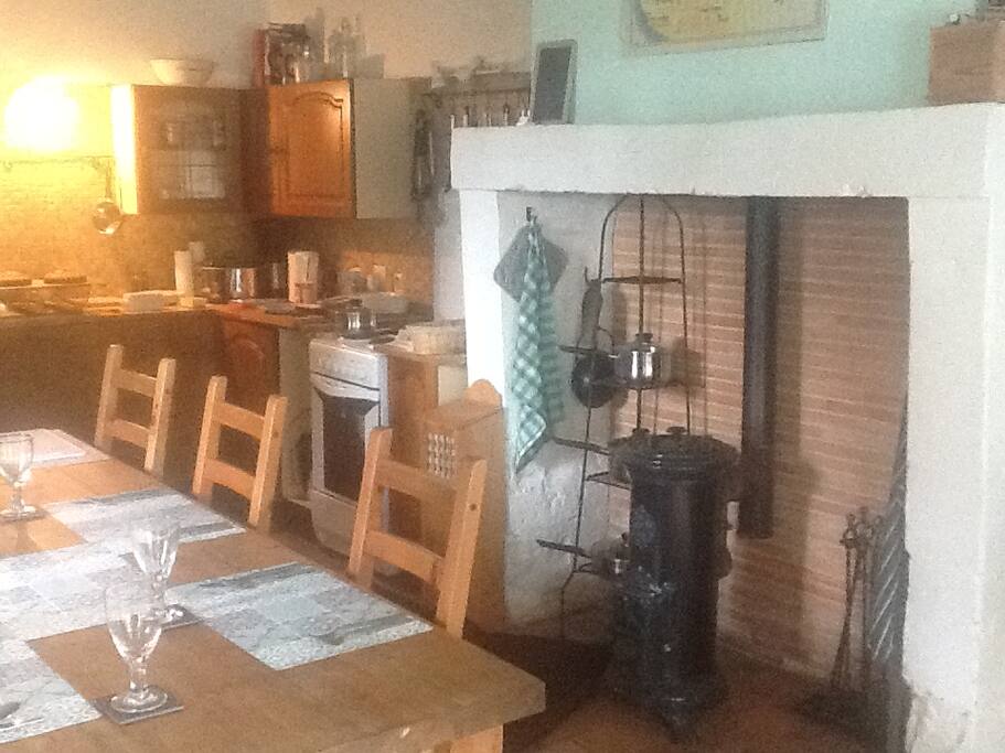 Dining room with large fireplace anf wood burning stove