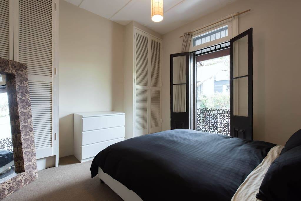 Bedroom A: Large spacious bedroom with comfortable bed. Outdoor deck area upstairs.