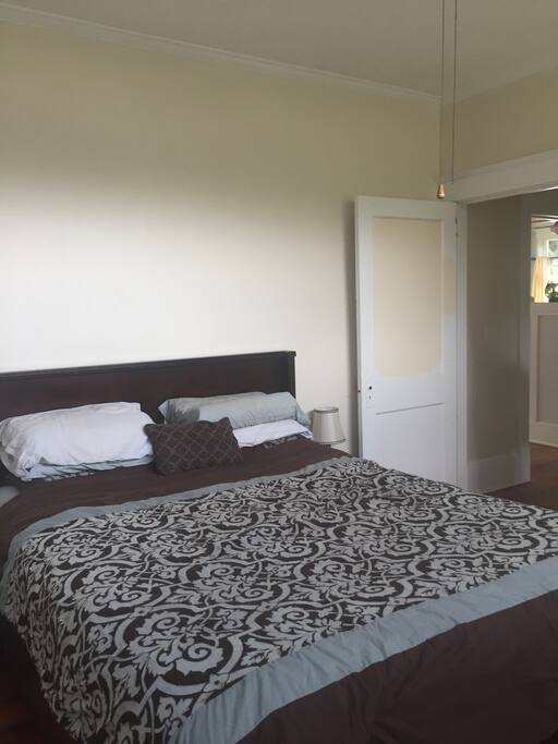 Bedroom offers a queen size bed, ceiling fan, 36' tv, a wall unit for extra air conditioning and hard wood floors.