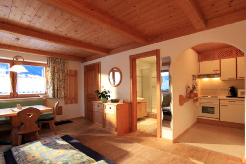 Open plan lounge with king size and single bed