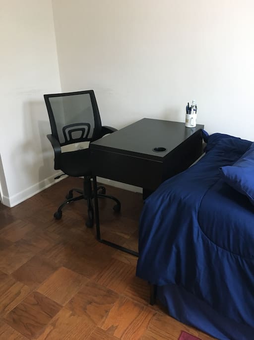 Study table with chair. Outlet located behind chair