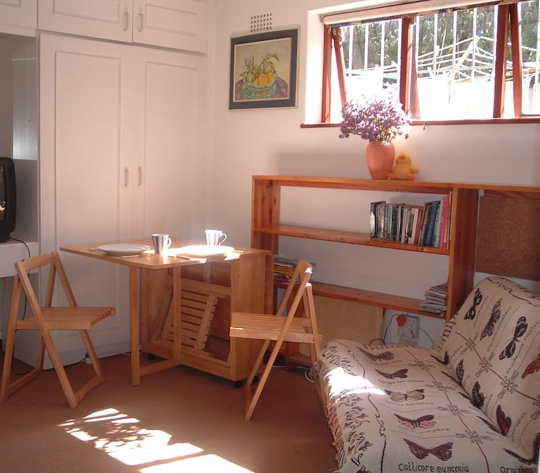 an expandible breakfast nook or work area. sleeper sofa. all can be folded away.