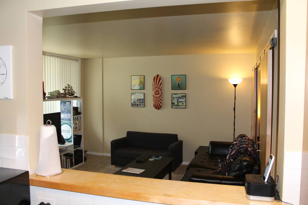 view of living room, with sodas, from kitchen.