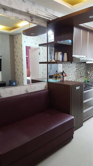 The living room, sofa bed and kitchen