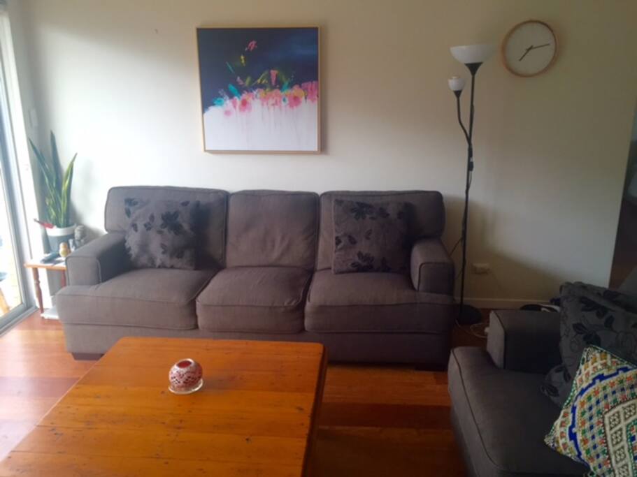 Large loungeroom with two comfy couches, tv and air-conditioning