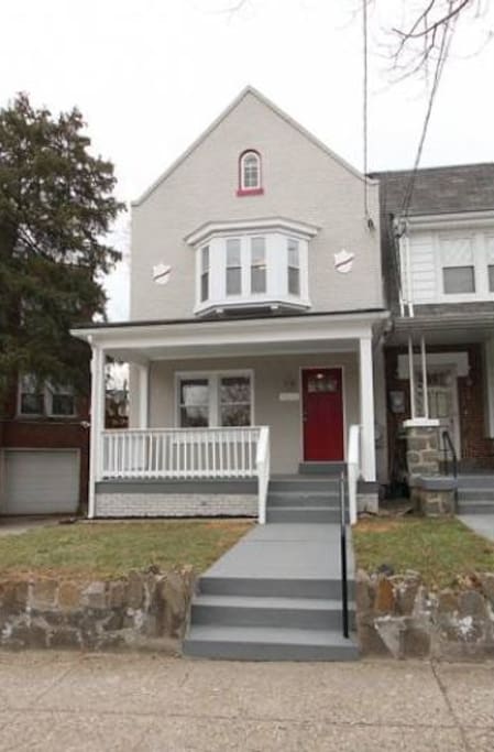 Basement apartment in end rowhouse (grey with red door).