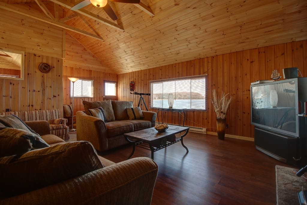 livingroom with a futon hiding behind the couch for that extra couple