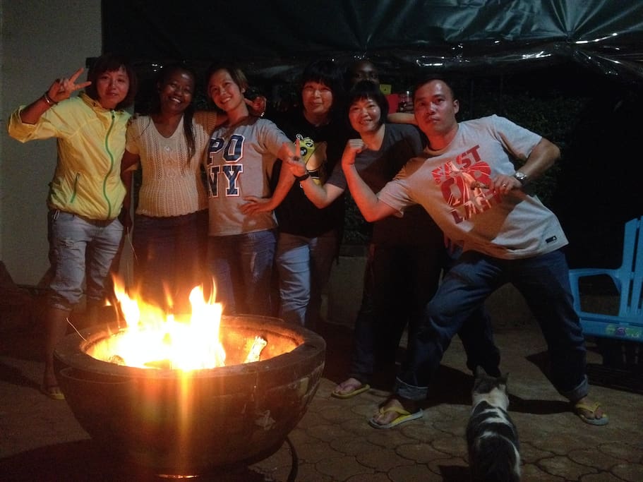 With happy guests enjoying a bonfire