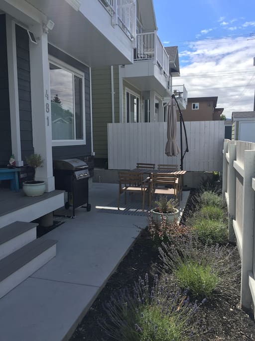 Patio space with privacy fence, BBQ, umbrella and table