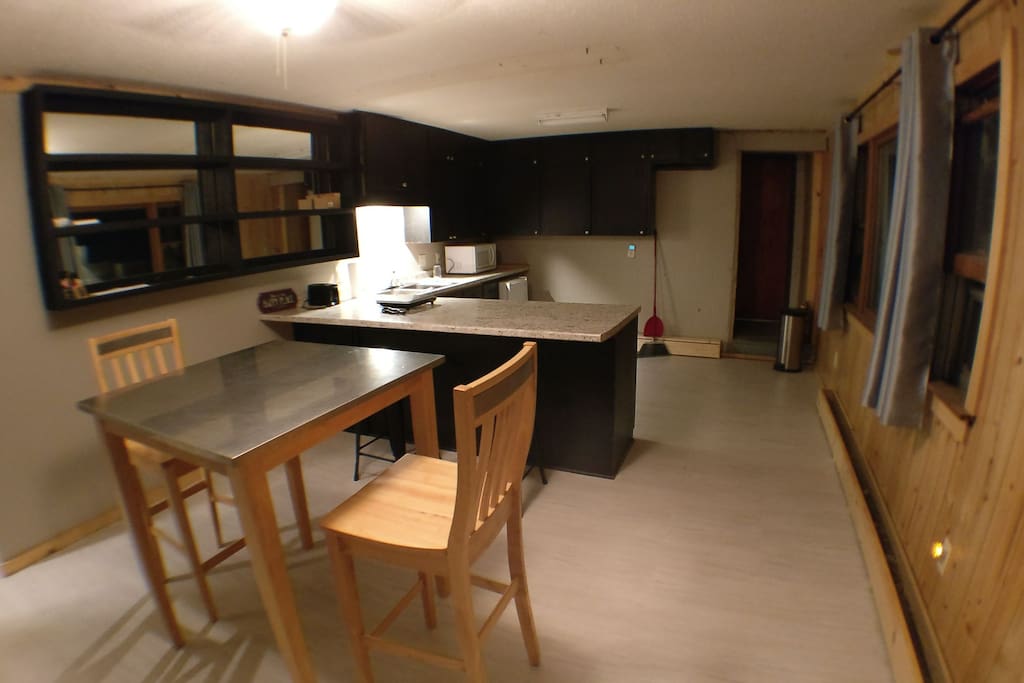 Dining room and kitchen. hot plate and mini fridge available. coffee maker and pancake griddle in the cabinets.