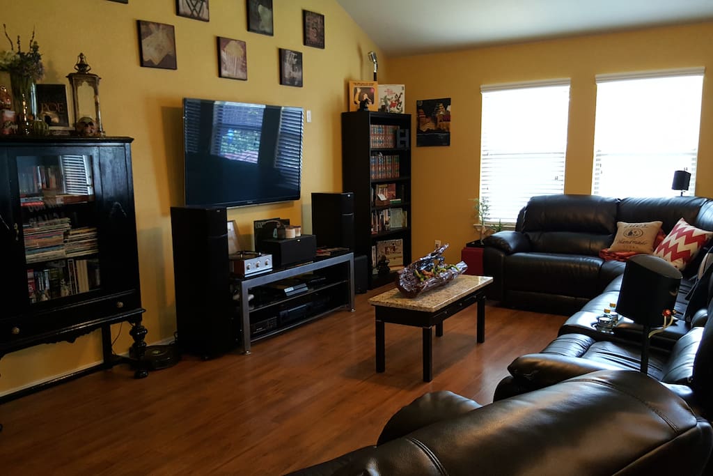 A cozy interactive living room with a 6-seater sectional. 3 chairs are auto-recliners.