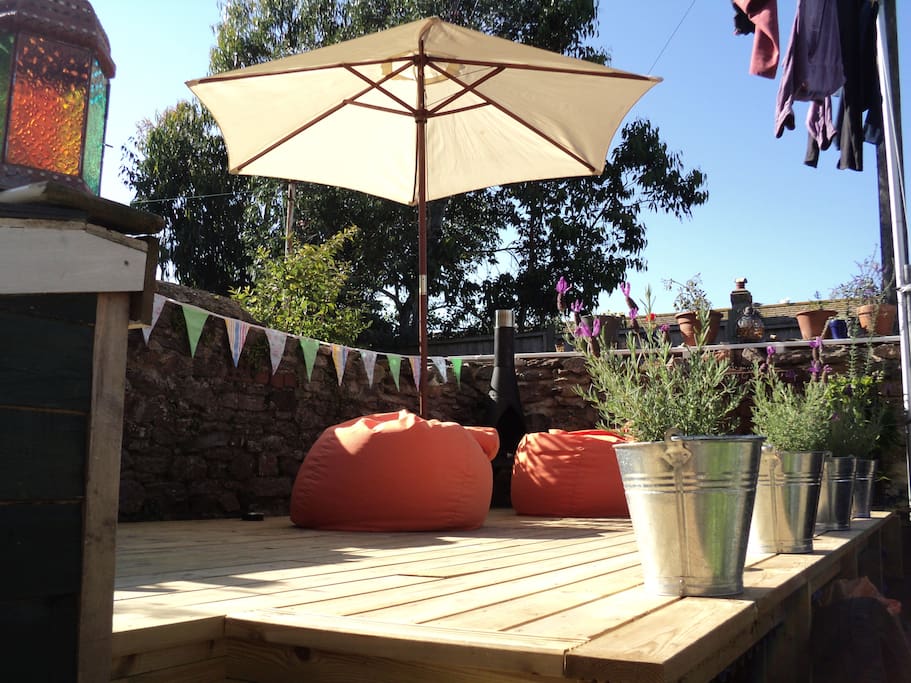 Our little yard provides a relaxing deck, with views along the terrace to the sea