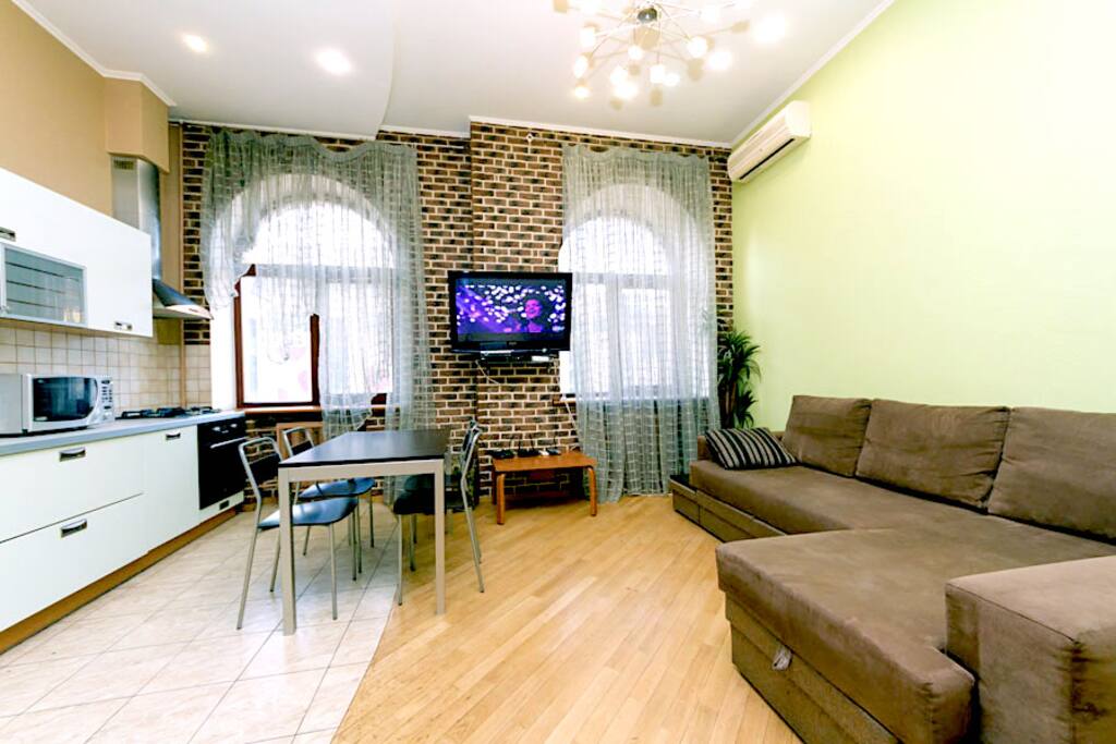 Very spacious living room overlooking the central Basseynaya Street, combined with a kitchen area, comfortable corner sofa bed can be used as an extra bed.