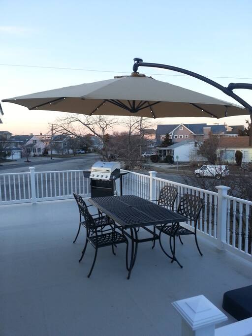 Side view of private deck with patio table and grill