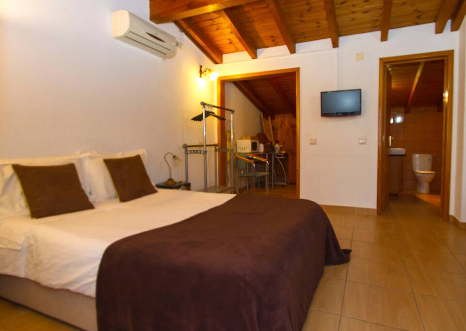 Bed, kitchen and bathroom view.