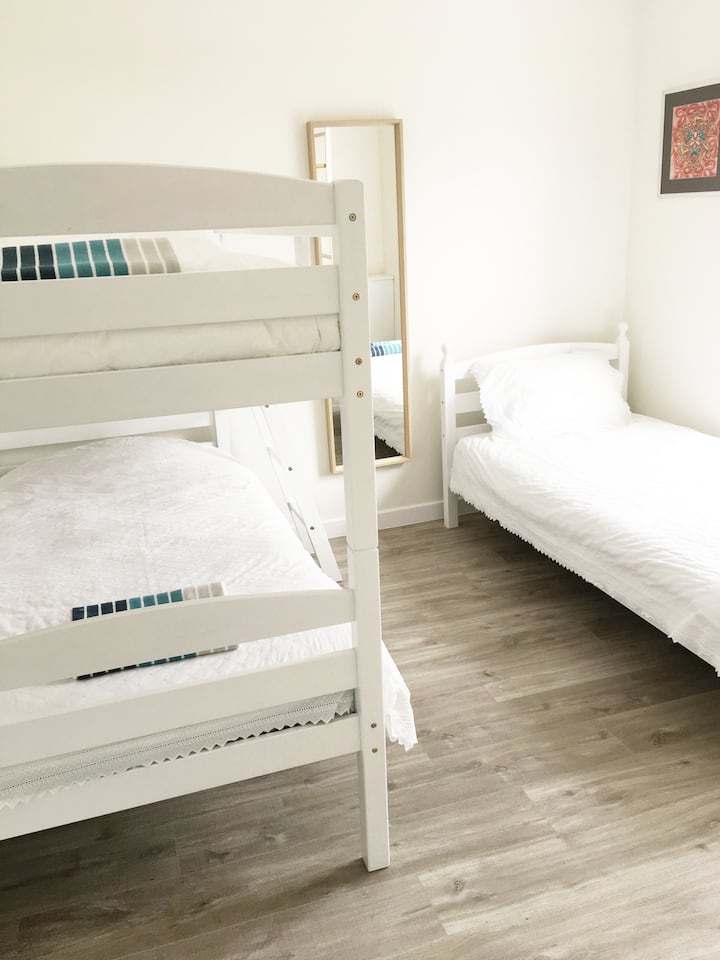 Light and airy bedroom that sleeps three people. One single bed and one bunk bed.