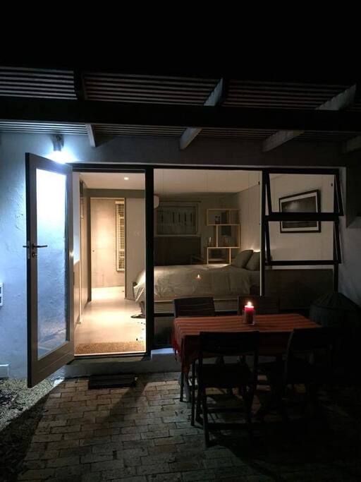 Private courtyard, patio with outdoor table and 4 chairs, Weber braai|grill and cooking tools, garden with colourful waterwise indigenous plants|flowers.