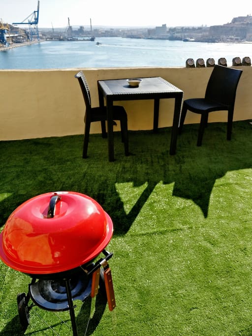 Roof Chillout area with terf, BBQ, Table and Four chairs, Umbrella and lay down area