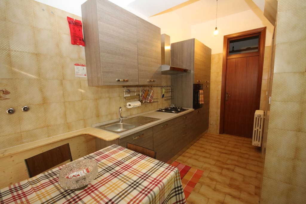 Kitchen area with built in pantry room.