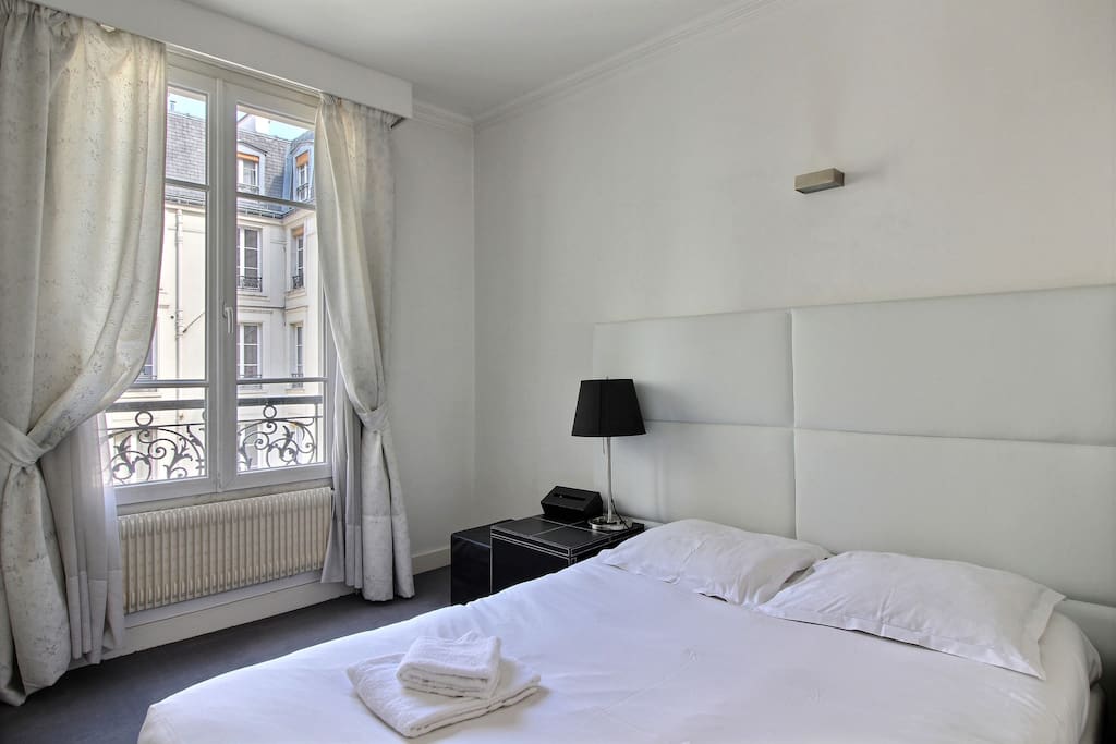 Bedroom with large double bed and cupboard
