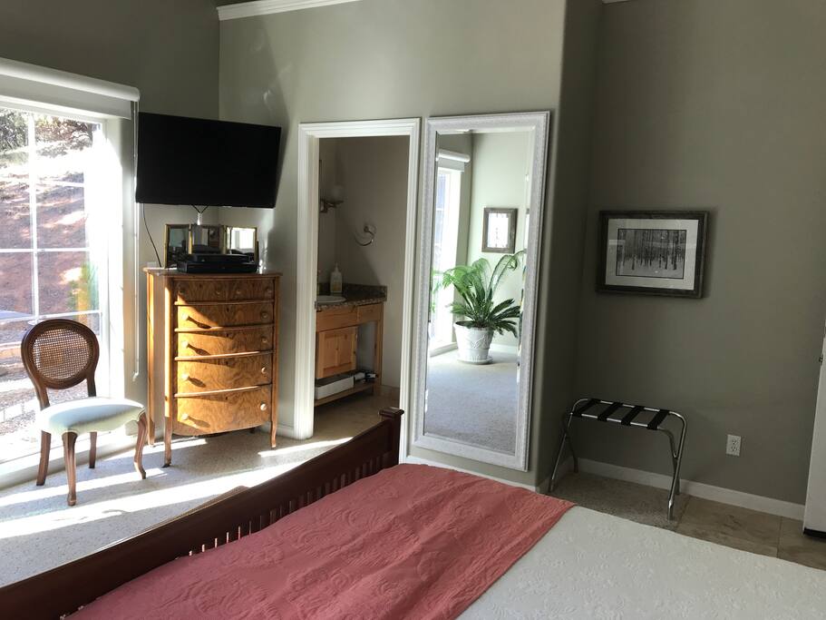 The master bedroom has a TV, dresser, large mirror and a lighted loft above, that you can't quite see in this picture, for soft mood lighting