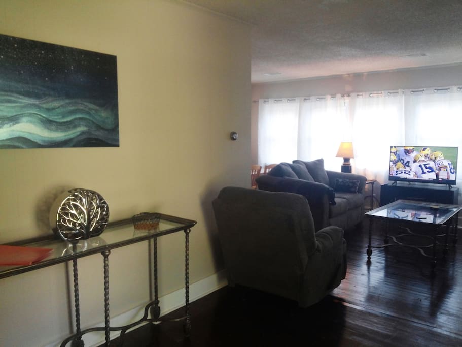 Entryway and living room view, including flat screen TV.