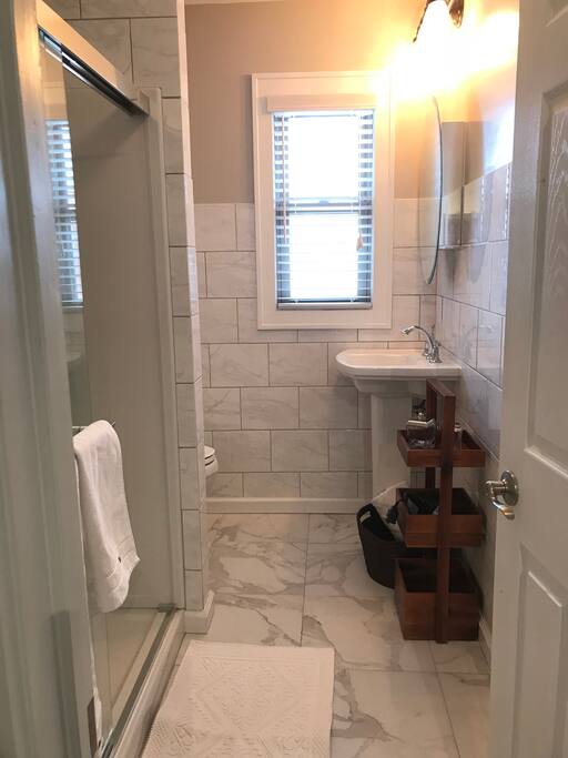 White Carrea Tiled Bath with shower
