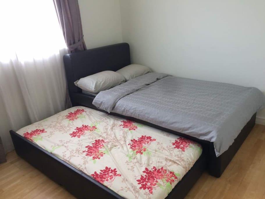 Super Single bed with single mattress below.