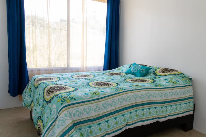 The third bedroom features a queen sized bed and lots of natural light.