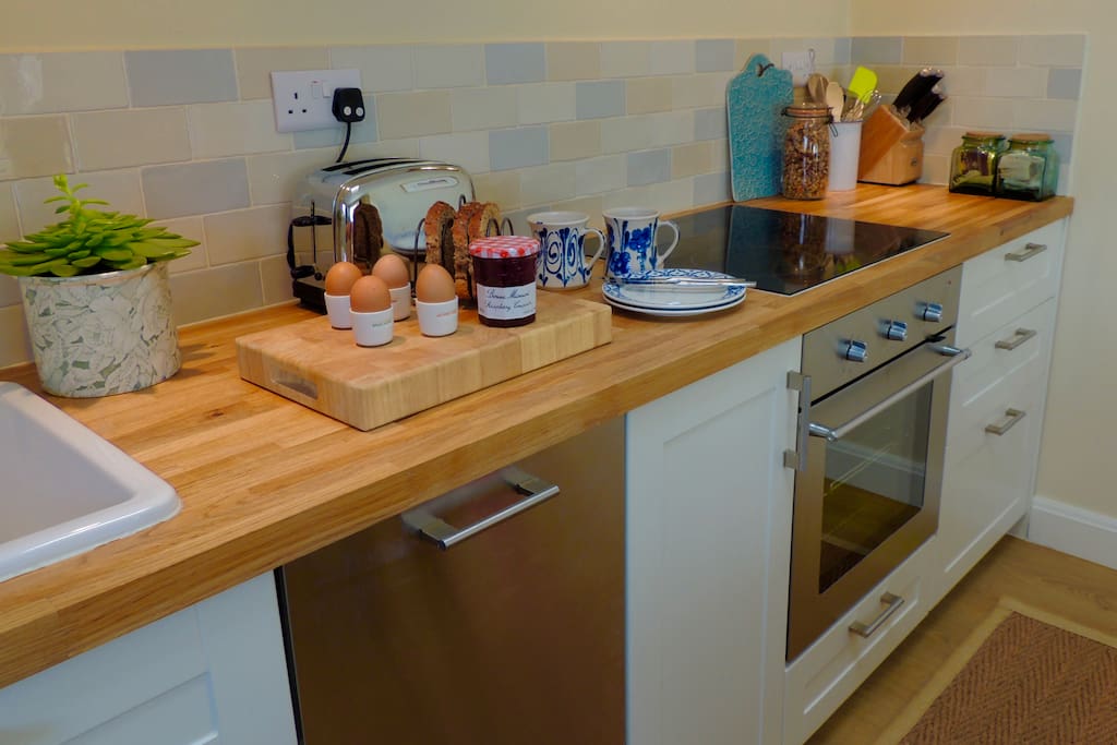 A fully equipped newly fitted kitchen with full sized dishwasher and electric oven with hob over.