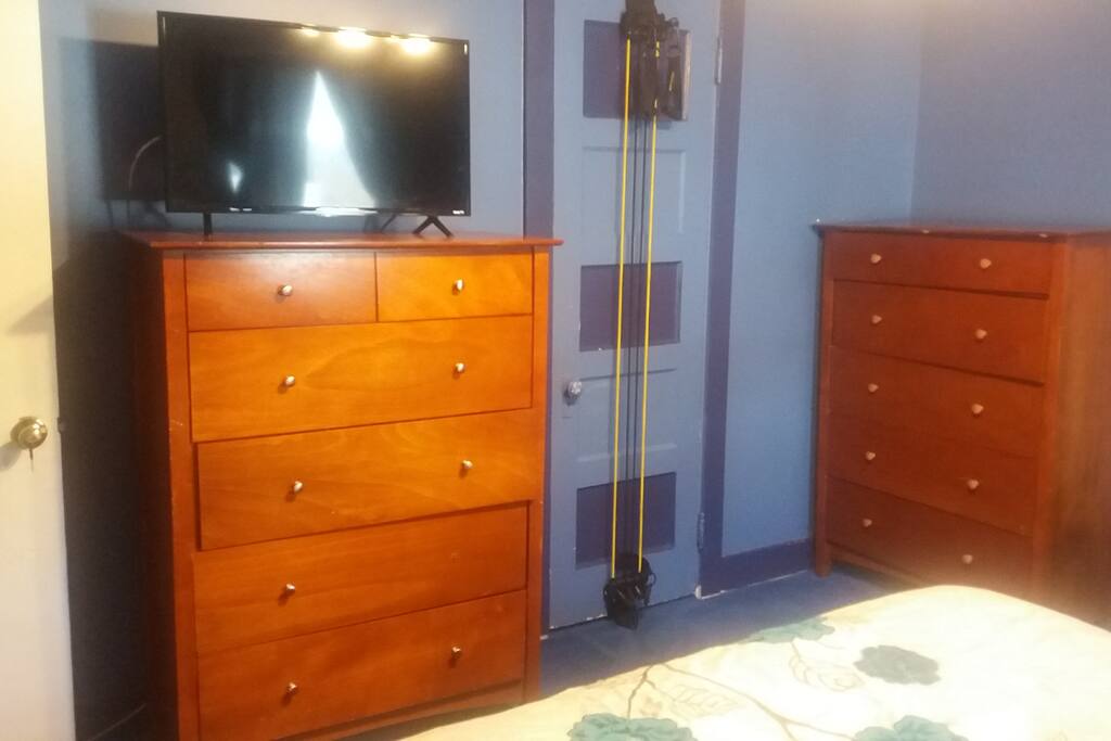 Dressers & flat screen TV in bedroom