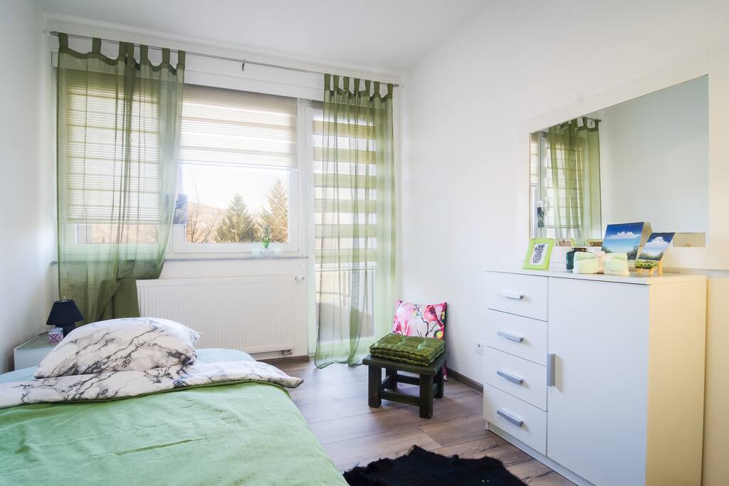 Bedroom with two wide beds - spacious and comfy at the same time. Enjoy the view from a balcony!