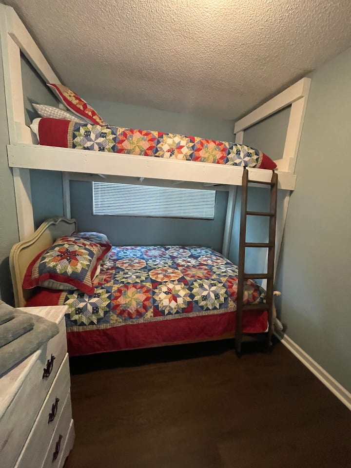 Second full bed in bedroom with bunk bed