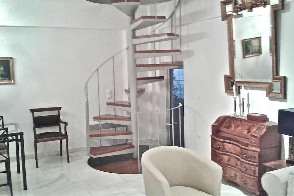 STUNNING SPIRAL STAIRCASE LEADS TO TWO OTHER LEVELS OF LIVING SPACE.