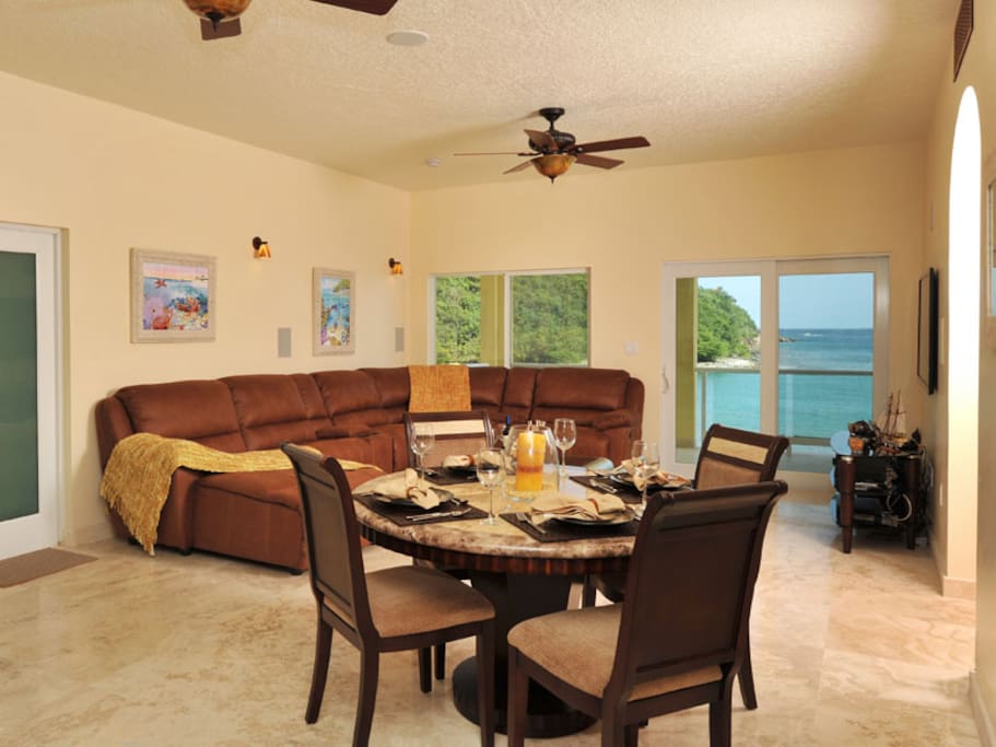 Spacious living and dining area, Home Theater System, sweeping ocean view balcony with outdoor dining Two Bedroom Two Bathroom Spa