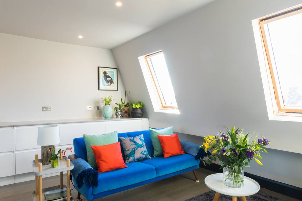 The comfy lounge area of the top floor loft space with view over the street below.