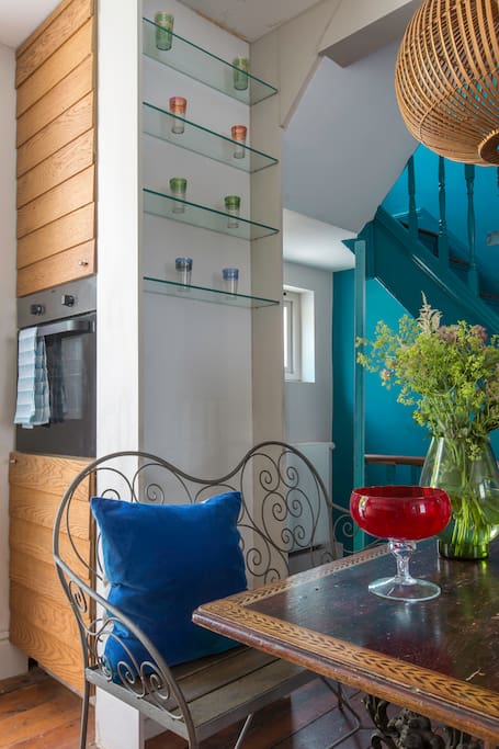 Stairs and dining table next to Kitchen
