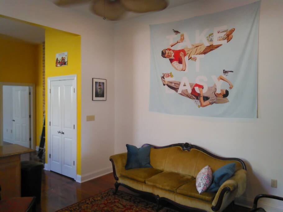 Enter the home into the living room. There's a sofa and chairs, books, magazines and brochures about NOLA, and a USB hub for charging your mobile devices. We think TV rots your brain, so you won't find one here, but we've got wifi if you want to connect your devices.