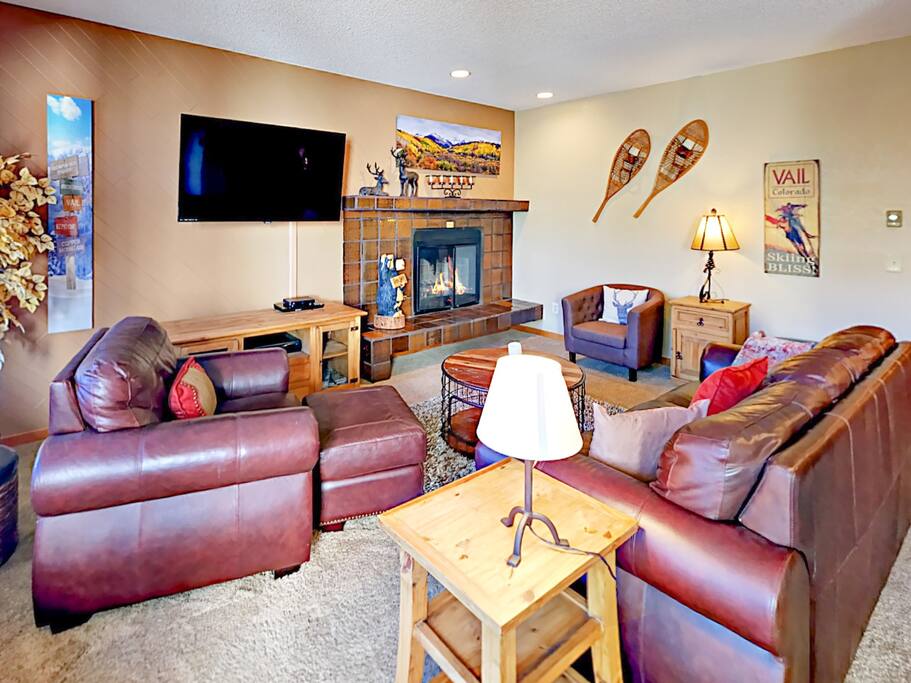 Stretch out on a leather sofa and 2 armchairs while the flickering fireplace warms the living space.