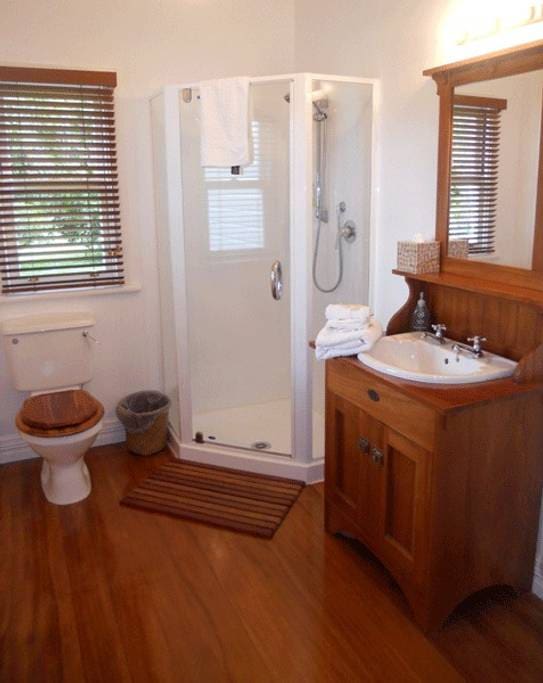 Ensuite bathroom with character features and shower.