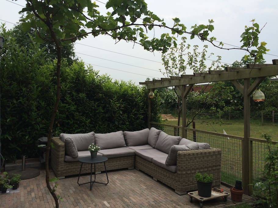 Heerlijke loungeplek achterin de zonnige tuin op het zuiden