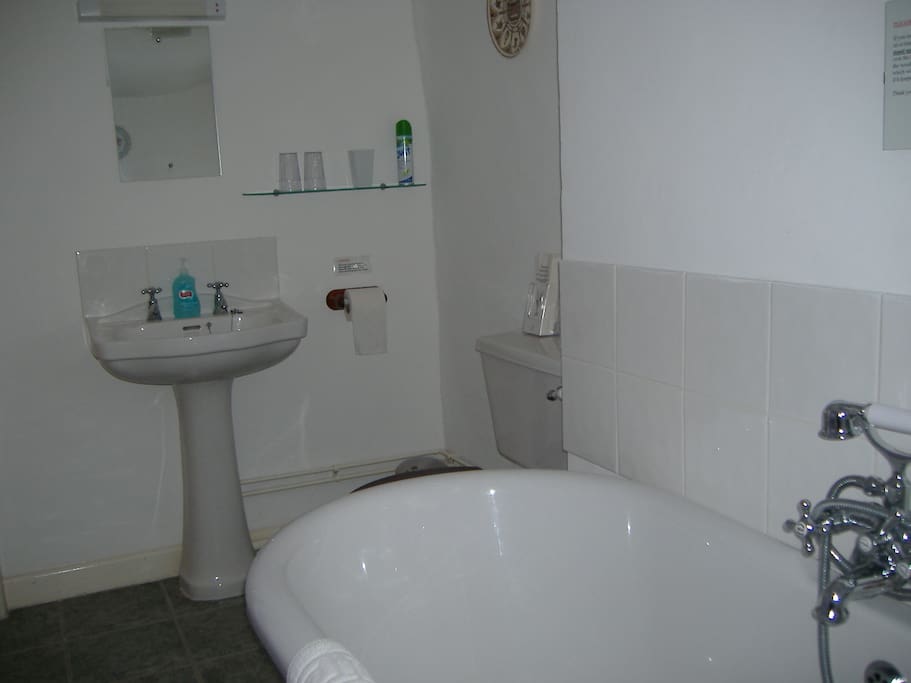 bathroom with roll top bath