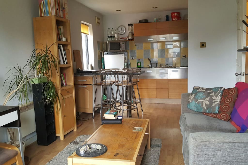 Living room. Breakfast bar and kitchen.